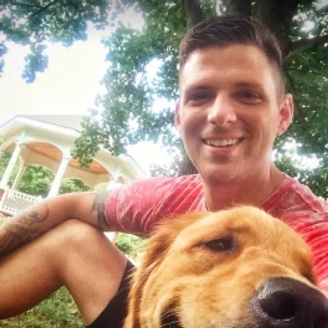 Selfie of Josh Walker and his service dog, Baxter